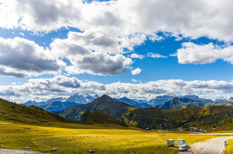 a van parked on the side of a road with mountains in the background, by Julia Pishtar, pexels contest winner, renaissance, panoramic view, alp, alpes, high resolution photo