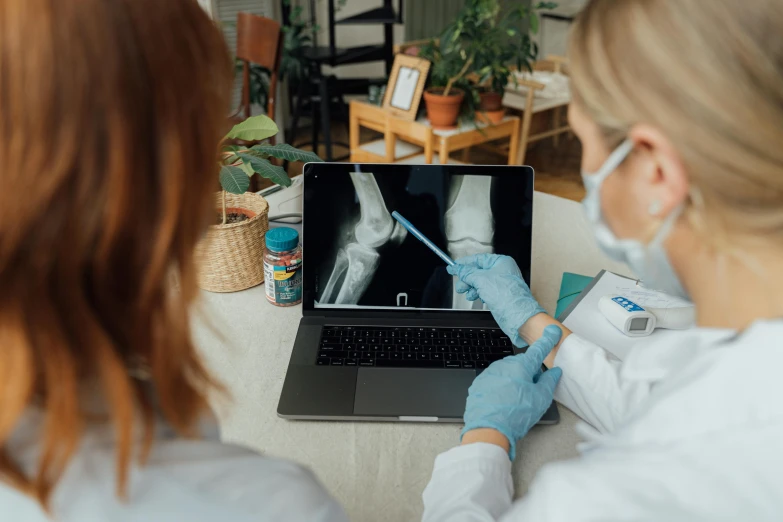 a woman sitting in front of a laptop computer, pexels contest winner, hyperrealism, bones joints, doctors mirror, inspect in inventory image, thumbnail