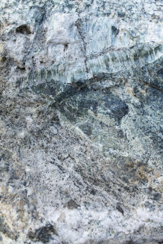 a close up of a rock with a face on it, by Rudolf Schlichter, unsplash, lyrical abstraction, the blue whale crystal texture, panorama, high angle close up shot, silver dechroic details