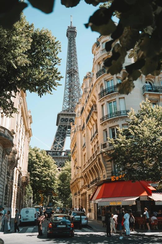 the eiffel tower towering over the city of paris, a photo, inspired by Albert Paris Gütersloh, trending on unsplash, summer street, 🦩🪐🐞👩🏻🦳, shady alleys, 8k ”