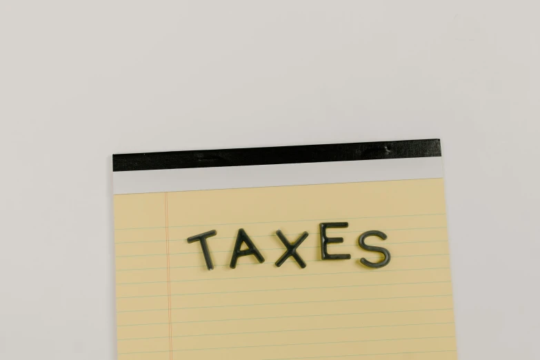 a piece of paper with the word taxes written on it, trending on pexels, conceptual art, tatsuro kiuchi, 1 6 x 1 6, tan, teaser