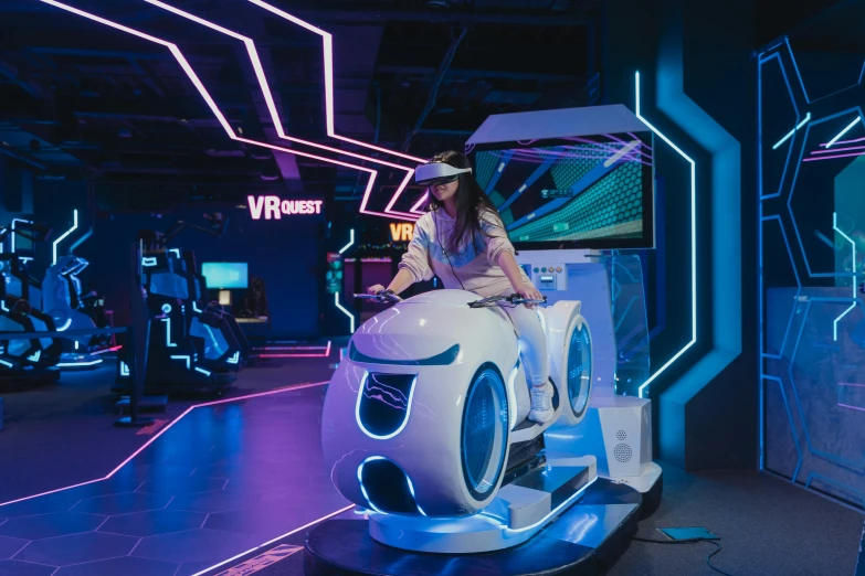 a woman sitting on top of a white car, a hologram, inspired by Jules Chéret, interactive art, vr helmet, a busy arcade, speeder, discovery zone