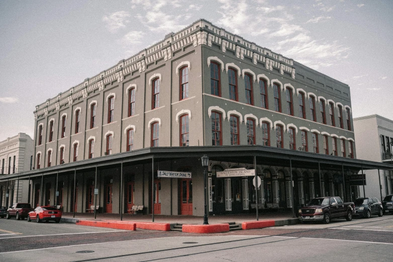 a large building sitting on the corner of a street, old west town, payne's grey and venetian red, moody iconic scene, in louisiana