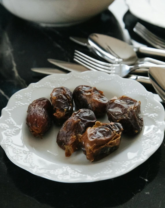 a close up of a plate of food on a table, by Julia Pishtar, hurufiyya, date, 6 pack, brown, malaysian