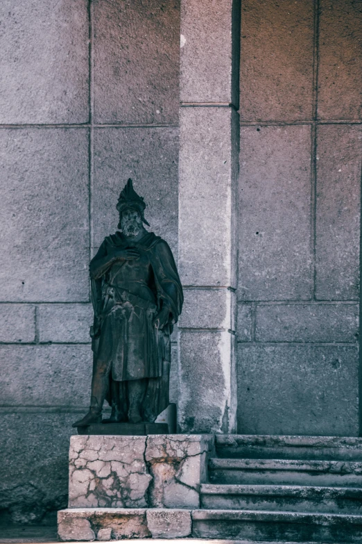 a statue of a man standing in front of a building, inspired by Ma Shi, unsplash, baroque, square, mongol, patina, grey