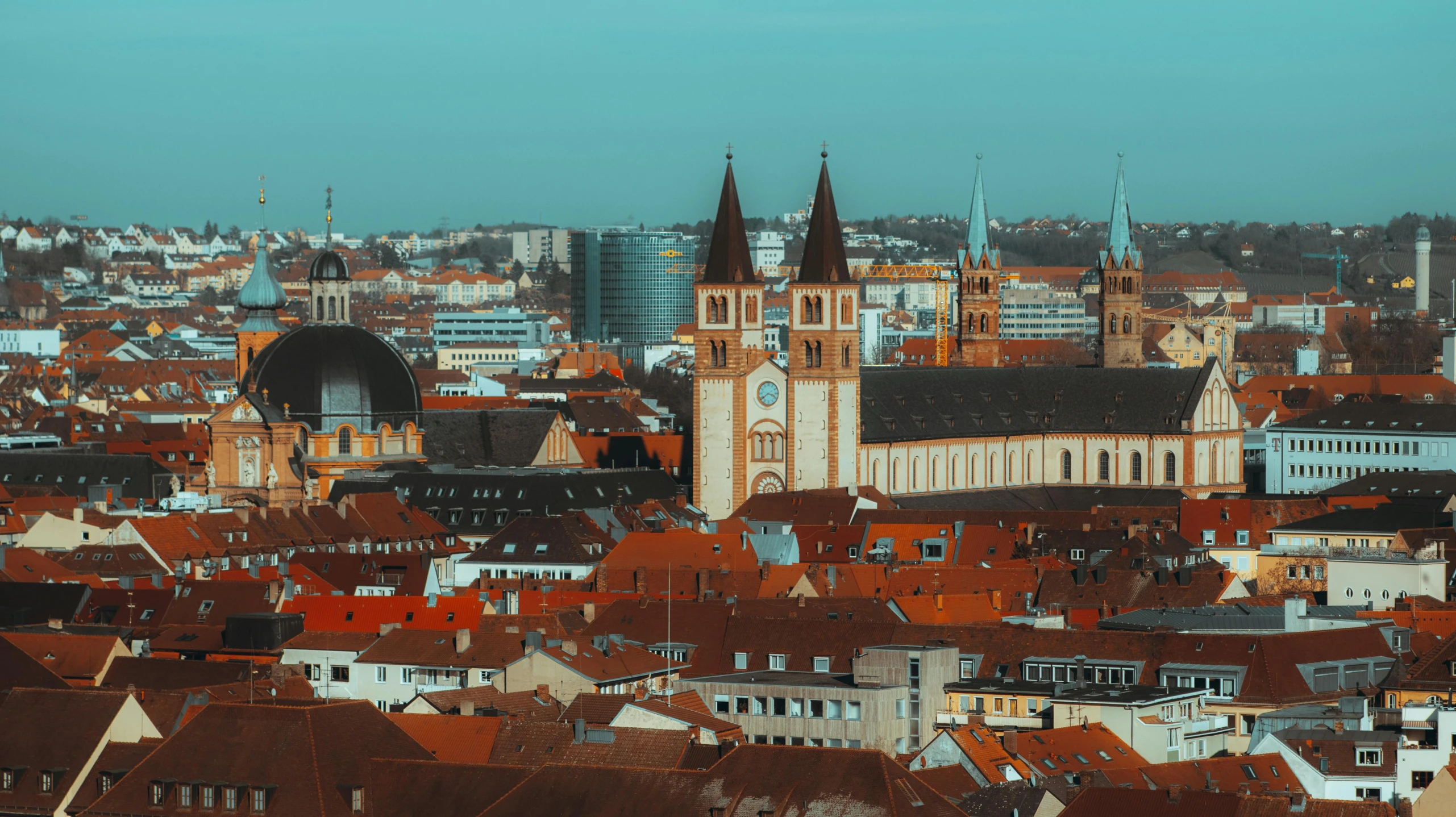 a view of a city from the top of a building, by Daniel Lieske, pexels contest winner, renaissance, red castle in background, germany. wide shot, black domes and spires, a colorful