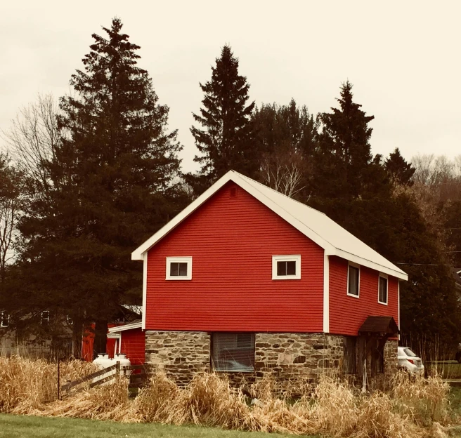 a red barn sitting in the middle of a field, pexels contest winner, hudson river school, rustic stone cabin in horizon, payne's grey and venetian red, joel meyerowitz, the house in the forest