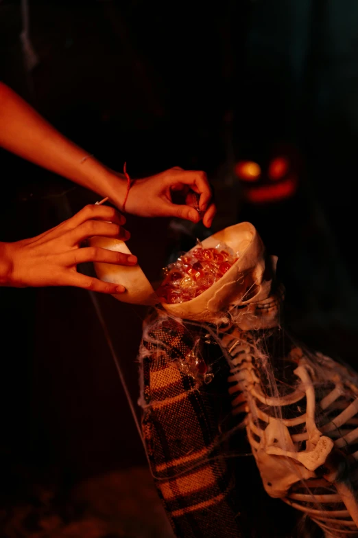 a close up of a person putting something in a shoe, vanitas, haunted house themed, glowing bones, fire from mouth, shibari