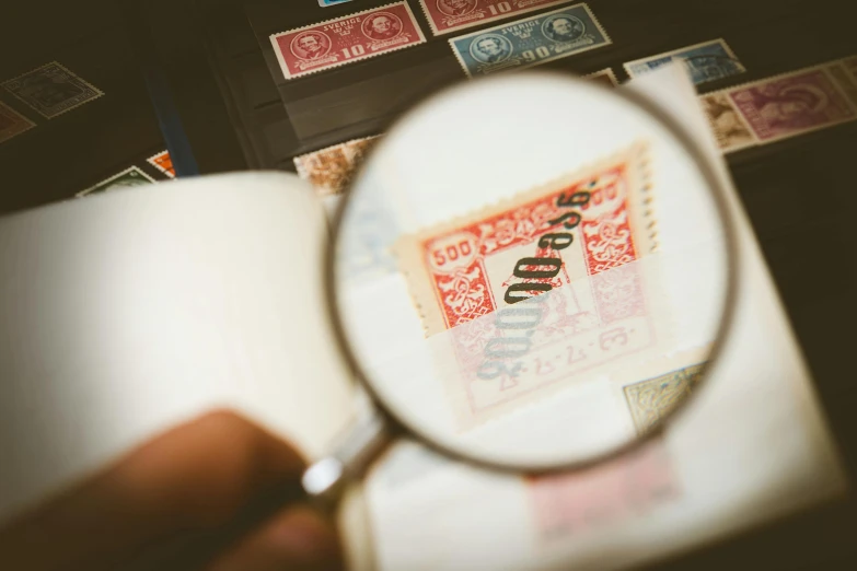 a person holding a magnifying glass over a book, a microscopic photo, pexels contest winner, private press, on a poststamp, surikov, brightly-lit, thumbnail