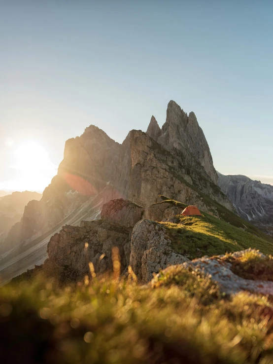 a man riding a bike up the side of a mountain, by Sebastian Spreng, pexels contest winner, renaissance, asymmetrical spires, late summer evening, panoramic view, in the dolomites