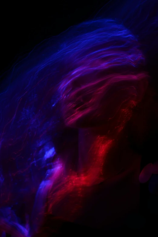 a blurry photo of a person holding a cell phone, unsplash, lyrical abstraction, red and blue black light, purple flowing hair, lightshow, body portrait