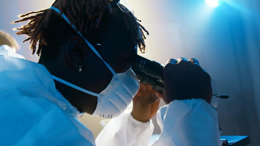 a man in a lab coat looking through a microscope, pexels contest winner, afrofuturism, young thug, profile image, staff wearing hazmat suits, thumbnail