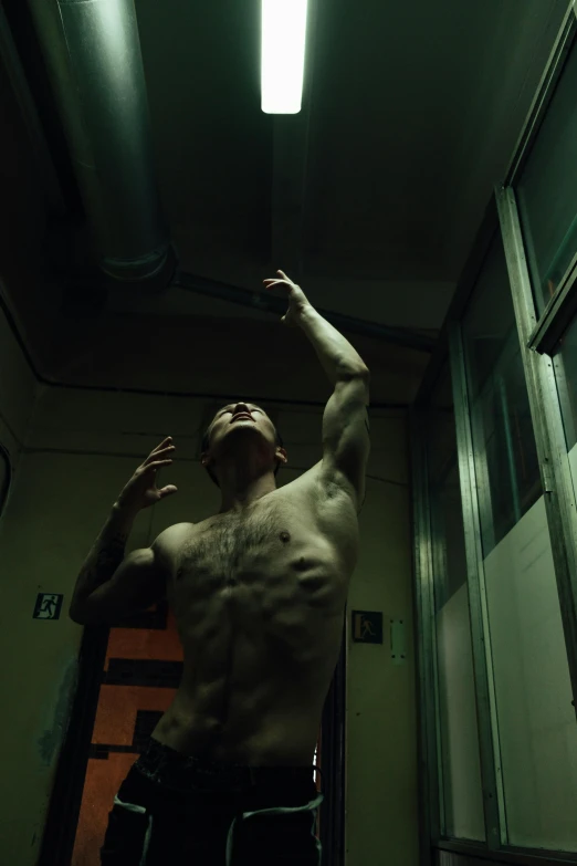 a shirtless man reaching up to catch a frisbee, a tattoo, by Alessandro Allori, symbolism, in a darkly lit laboratory room, **cinematic, leonid, ( ( theatrical ) )