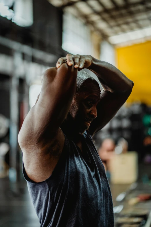 a man lifting a barbell in a gym, a portrait, by Dan Frazier, pexels contest winner, happening, scratching head, huell babineaux, pixeled stretching, man is with black skin