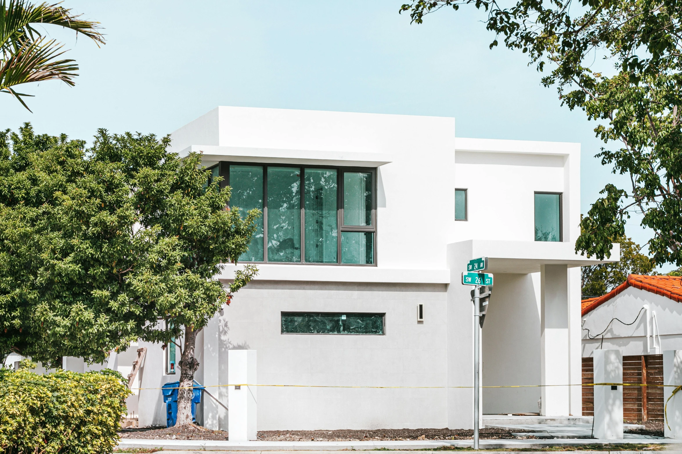 a red fire hydrant sitting in front of a white house, a digital rendering, by Carey Morris, unsplash, modernism, kicking a florida mansion, mies van der rohe, mixed development, white concrete