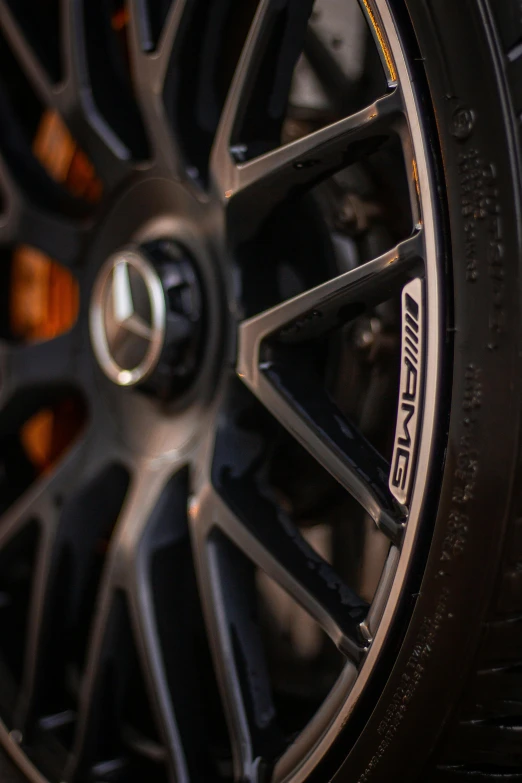 a close up of a tire on a car, intricately detailed markings, mercedez benz, taken with sony alpha 9, forged