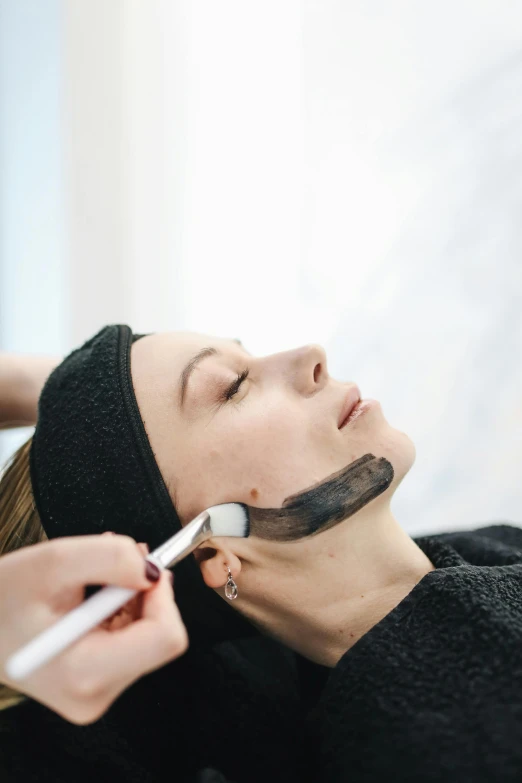 a woman getting a facial mask at a beauty salon, by Nicolette Macnamara, square masculine jaw, thumbnail, plating, bedhead