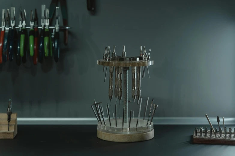 a bunch of tools sitting on top of a table, a 3D render, by Adam Marczyński, kinetic art, syringes, from witcher (2021), crown with pins, product display