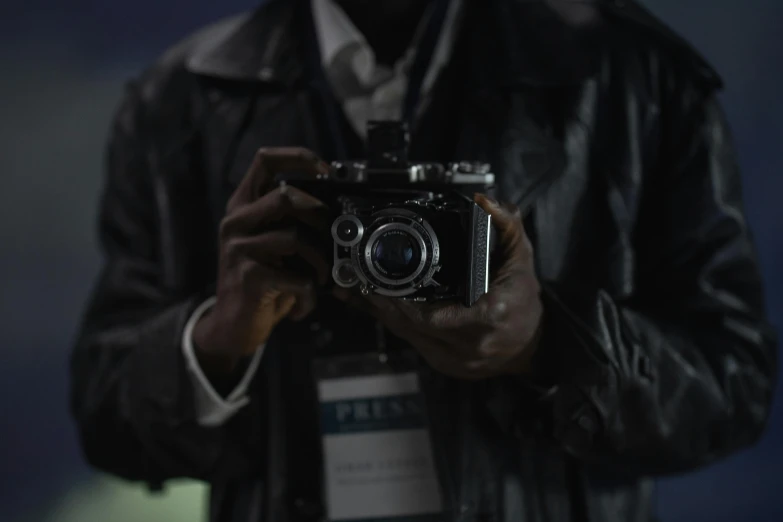 a close up of a person holding a camera, inspired by Gordon Parks, world press photo, panavision x iii, f/9, precision