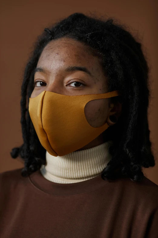 a woman wearing a yellow face mask, by Nina Hamnett, matte surface, brown, see - through, plain