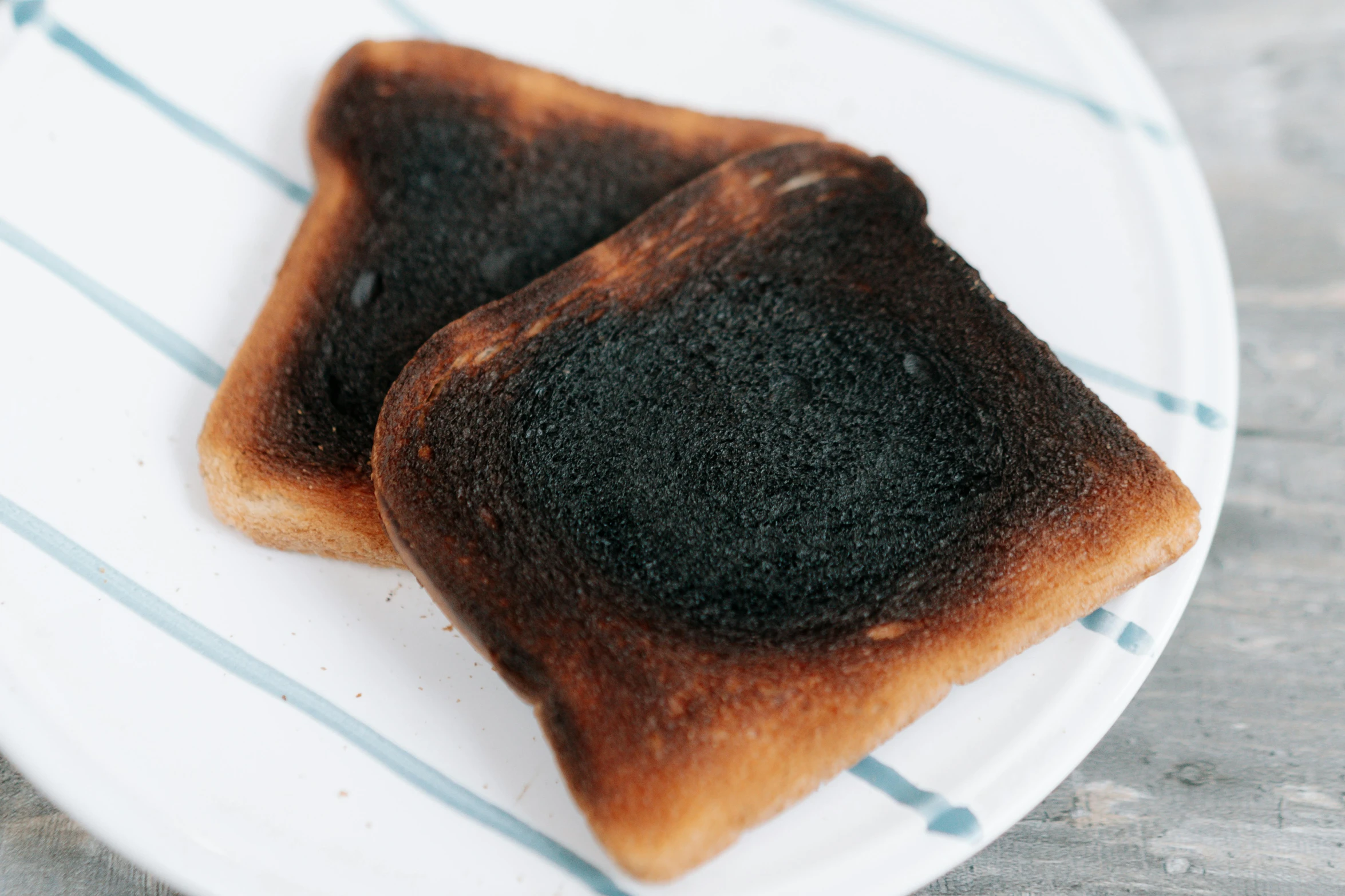 a close up of two pieces of toast on a plate, unsplash, auto-destructive art, smokey burnt envelopes, square, australia, background image