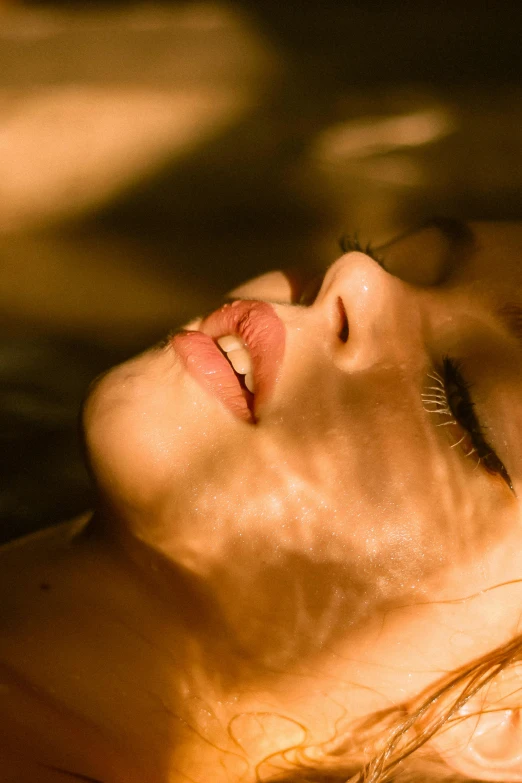 a close up of a person in a body of water, full lips, lying down, in the evening