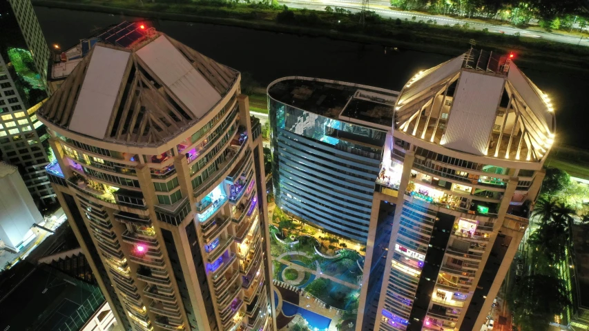 a couple of tall buildings sitting next to each other, pexels contest winner, hyperrealism, aerial photo night vision, curvy build, outdoors tropical cityscape, 360 degree view