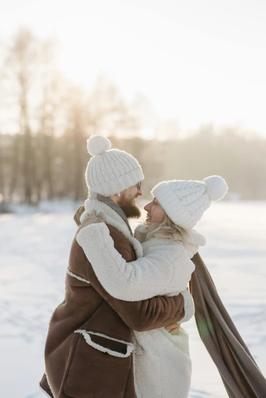 a man and woman hugging in the snow, pexels contest winner, cute hats, square, scandinavian, gif