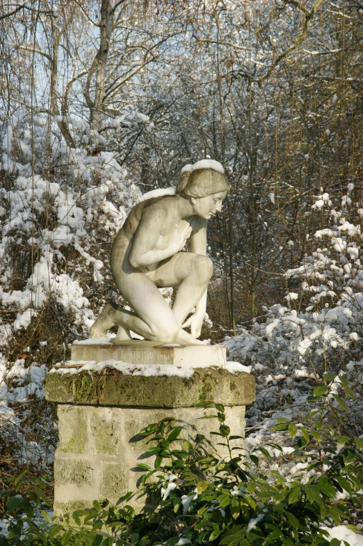 a statue that is sitting in the snow, inspired by Nassos Daphnis, exterior botanical garden, mercury, lush surroundings, andré le nôtre