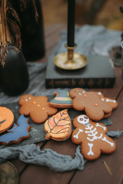 a table that has some cookies on it, by Julia Pishtar, spooky autumnal colours, high angle close up shot, cute details, a small