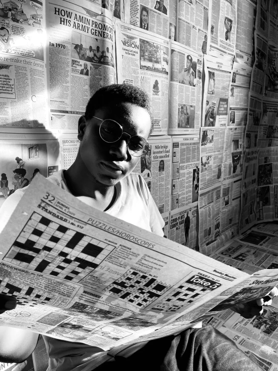 a man sitting on a bed reading a newspaper, a black and white photo, visual art, on a checkered floor, obunga, overhead sun, portrait of pele