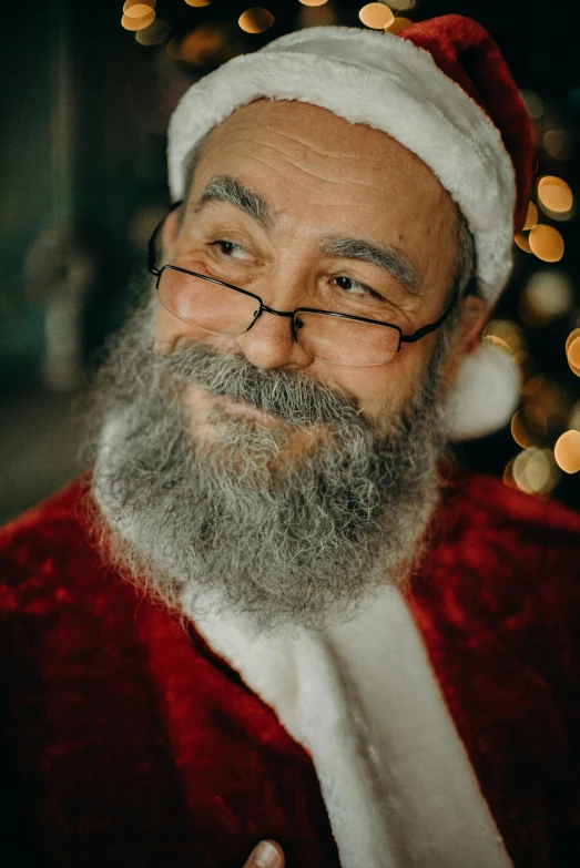 a close up of a person wearing a santa suit, a photo, by Sam Dillemans, hurufiyya, some grey hair in beard, promo image, wholesome, indoor picture