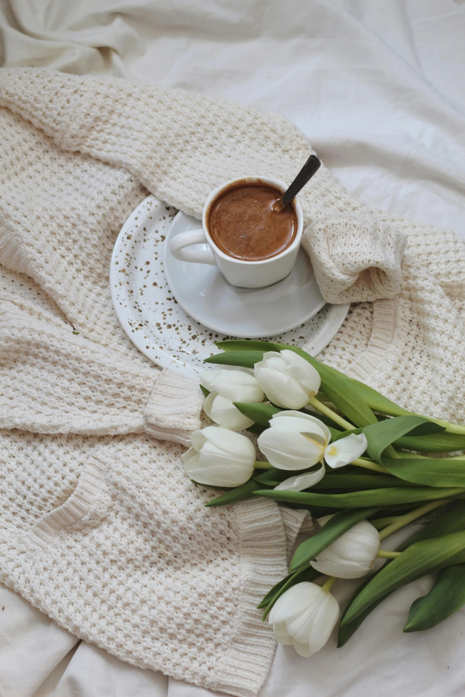 a cup of coffee and a bouquet of tulips on a bed, pexels contest winner, hot cocoa drink, boho neutral colors, soup, white hue