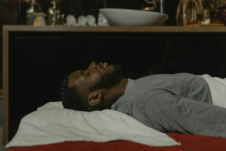 a man laying on a bed with his eyes closed, black man, healing pods, practical effects, head and body