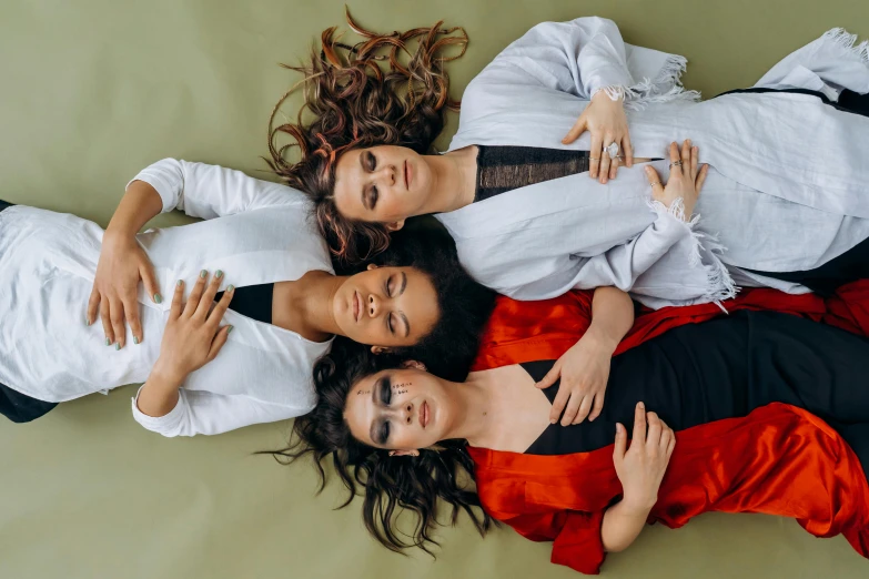 a group of people laying on top of a bed, by Emma Andijewska, trending on pexels, renaissance, three women, stylish pose, wavy hair spread out, 15081959 21121991 01012000 4k