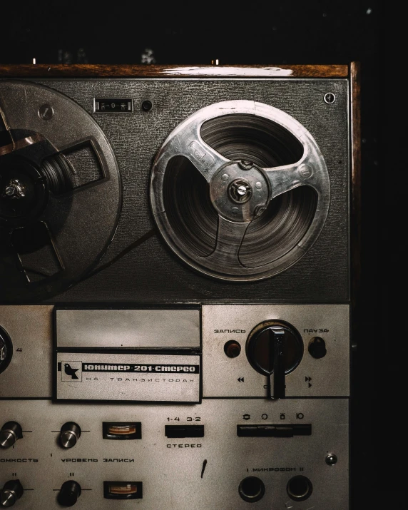 a close up of a machine on a table, an album cover, trending on pexels, old movie, audio equipments, head shot, tape