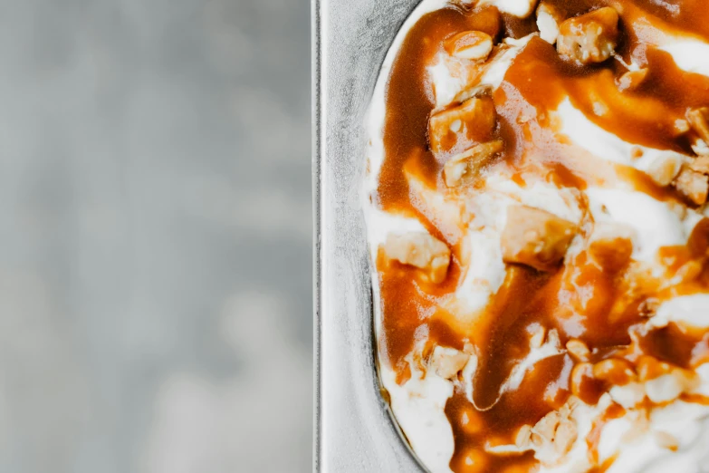 a scoop of ice cream with caramel sauce and nuts, a portrait, by Emma Andijewska, trending on unsplash, mapo tofu, close up to a skinny, detailed product image, filling the frame