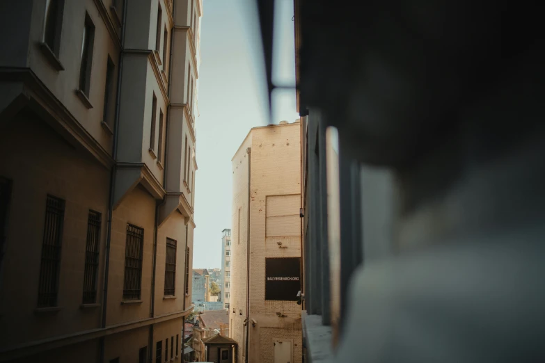 a couple of buildings that are next to each other, a statue, pexels contest winner, hyperrealism, looking outside, alleys, small depth of field, golden hour time