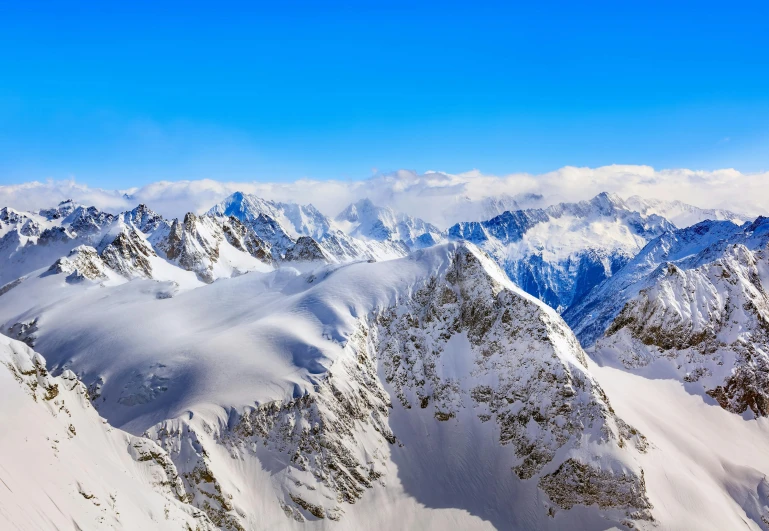 a group of people standing on top of a snow covered mountain, mountain ranges, 8k resolution”, “ aerial view of a mountain, lpoty