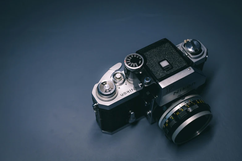 a close up of a camera on a table, on a gray background, today's featured photograph, vintage aesthetic, medium format