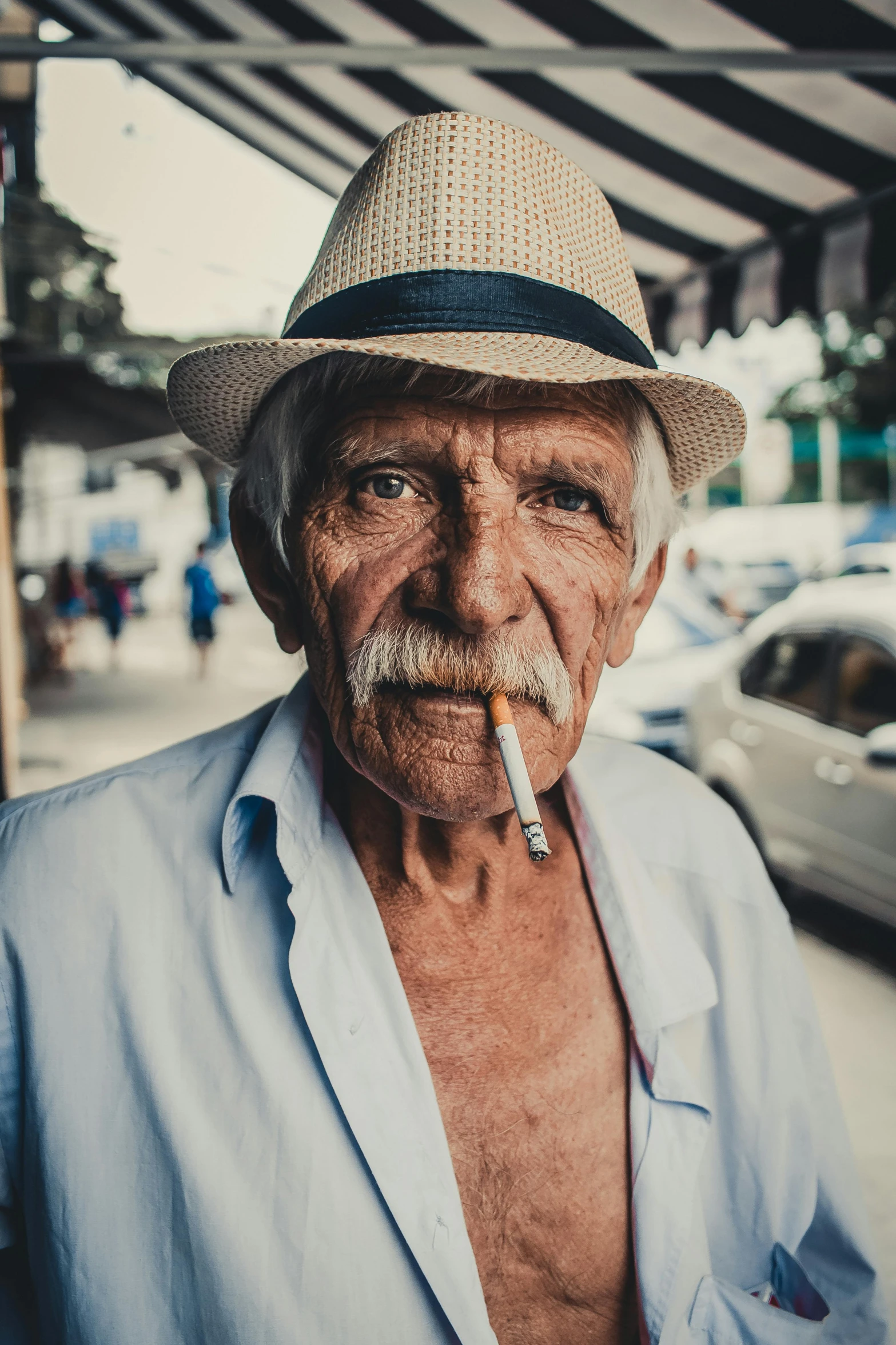 a man in a hat smoking a cigarette, by Alejandro Obregón, pexels contest winner, hyperrealism, old color photograph, portrait of a old, tourist photo, grumpy [ old ]