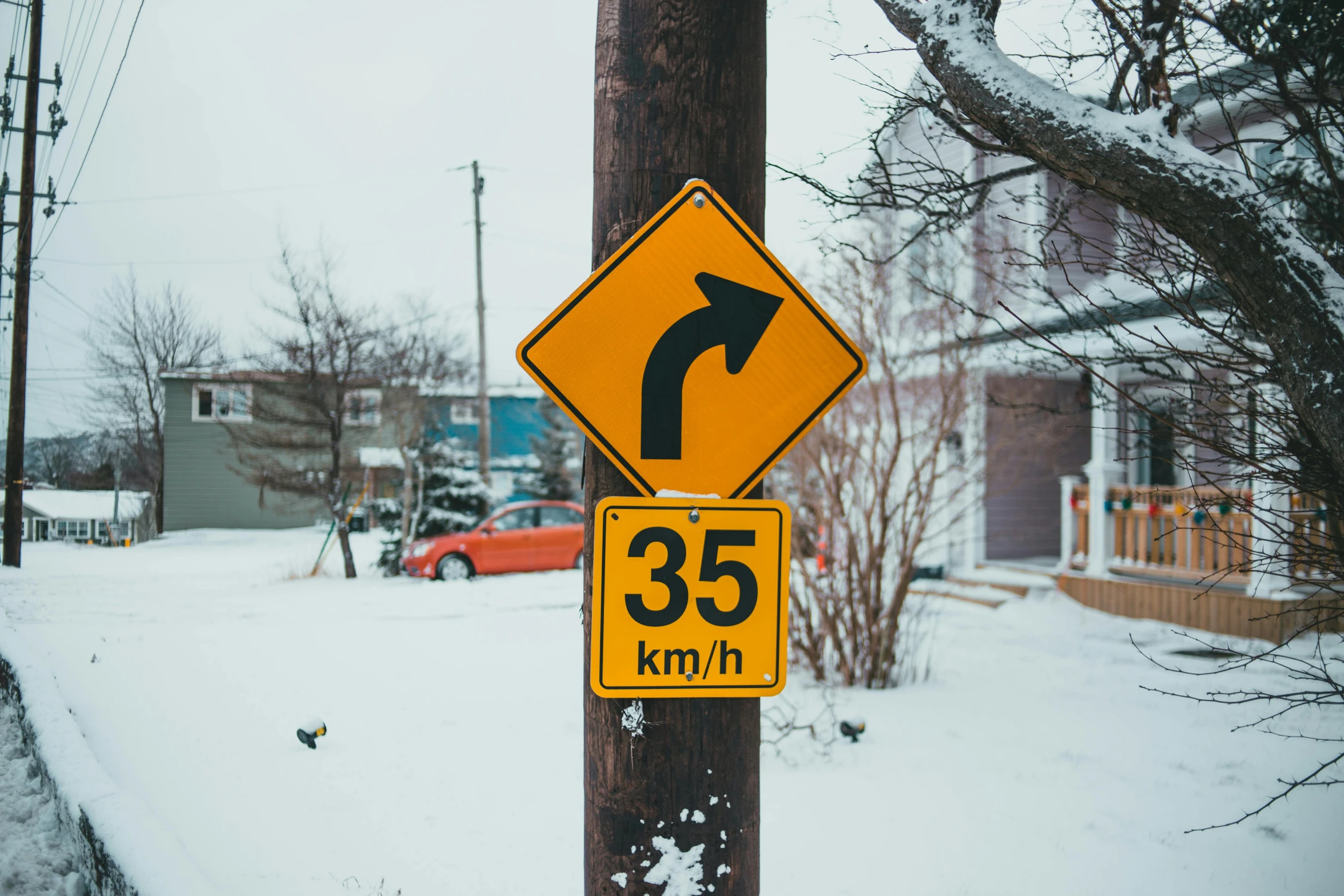 a close up of a street sign on a pole, by Adam Marczyński, pexels contest winner, ice arrows, flat roads, showing curves, skidding