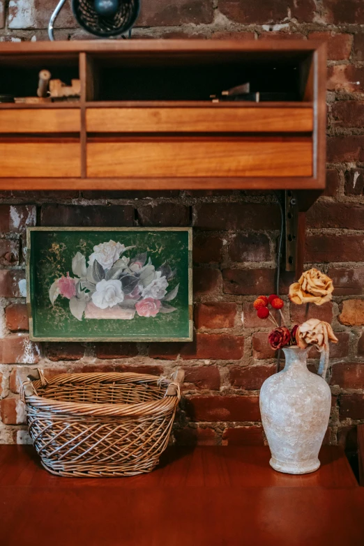 a couple of vases sitting on top of a wooden table, brick walls, gallery display photograph, wicker art, bouquet