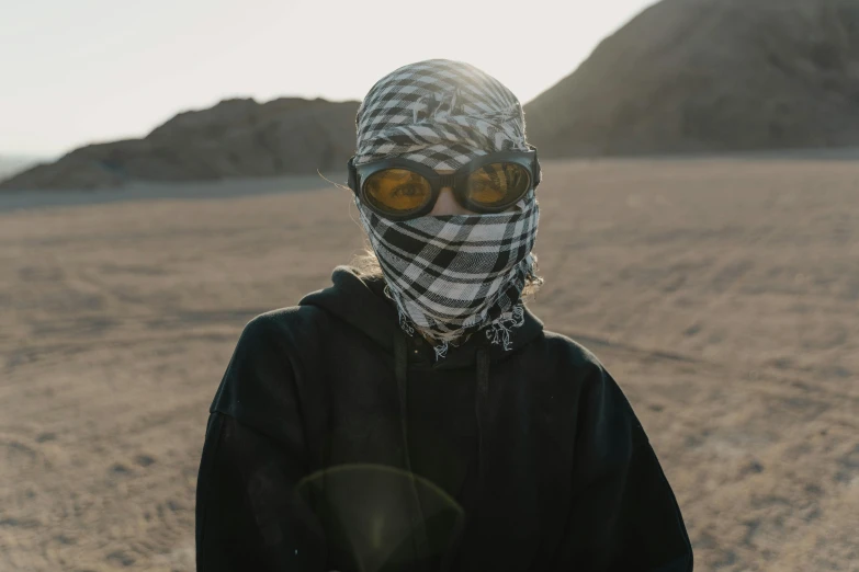 a person standing in the middle of a desert, ski mask, bandana, gen z, veiled