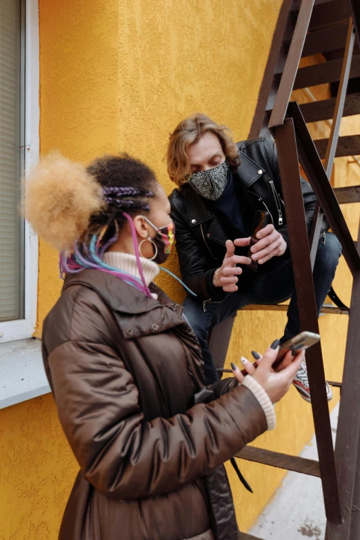 a couple of women standing next to each other on a ladder, a photo, trending on pexels, renaissance, wearing facemask, looking at his phone, jamie campbell bower, ashteroth