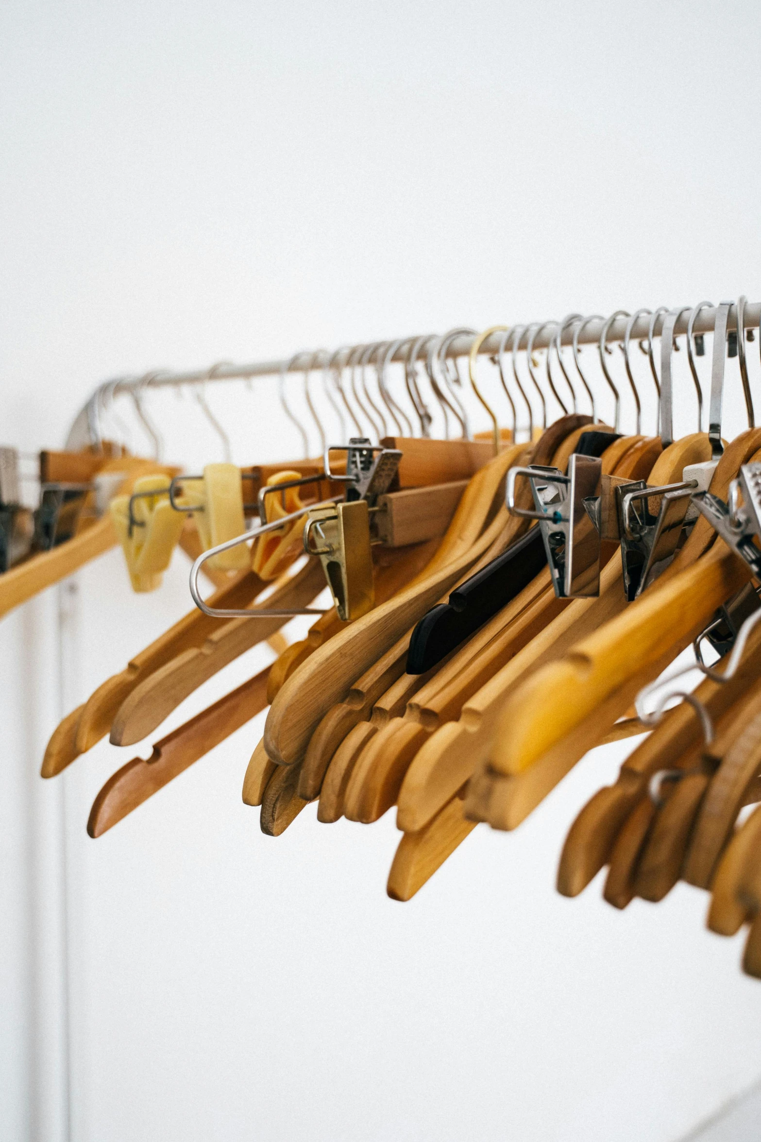 a bunch of clothes hanging on a rack, made of bamboo, inspect in inventory image, up-close, iconic design