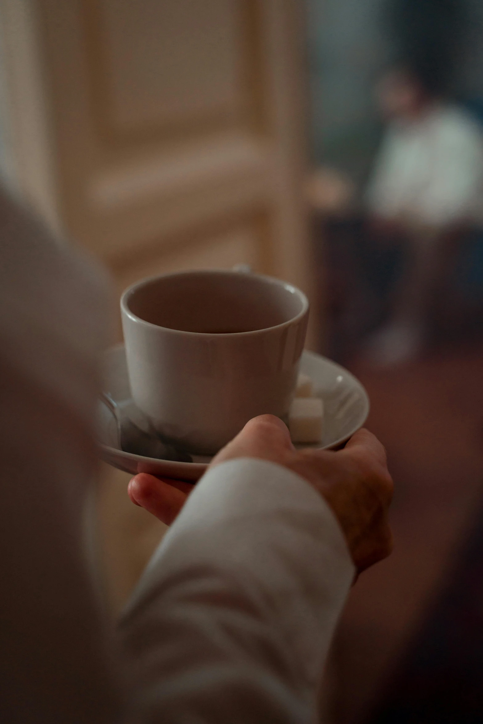 a close up of a person holding a cup and saucer, in the evening, fine details 8k octane rendering, **cinematic, 8k 50mm iso 10