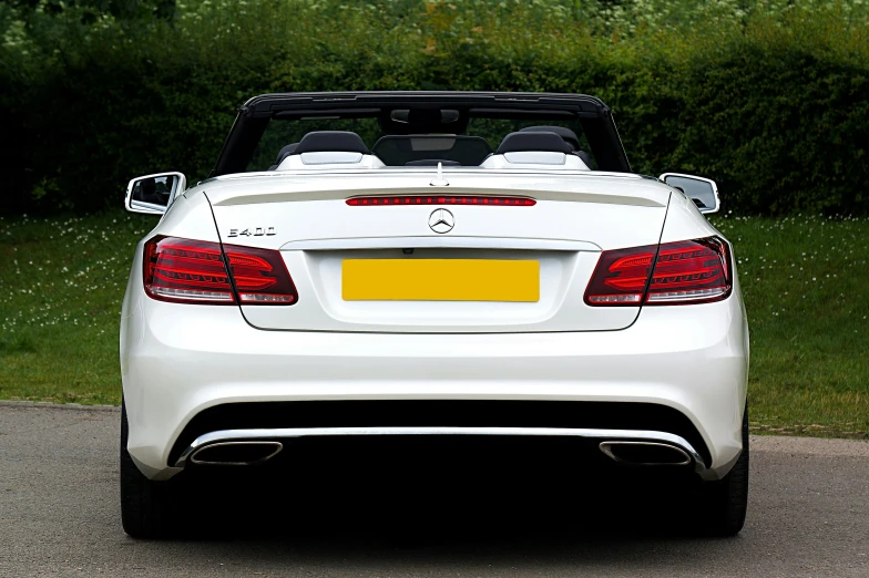 a white car parked on the side of the road, by Julian Allen, pixabay, convertible, rear lighting, mercedez benz, square