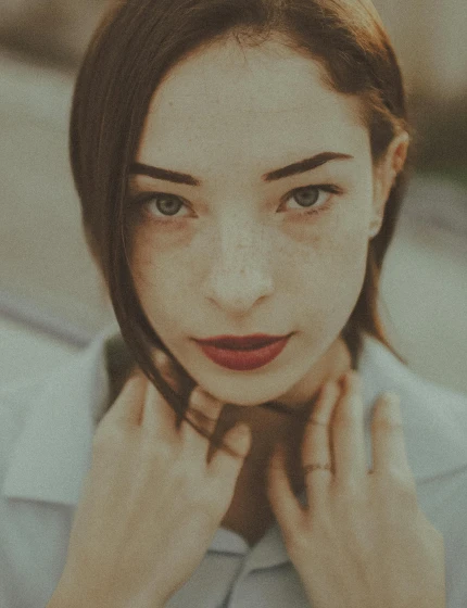 a close up of a person wearing a shirt, inspired by Elsa Bleda, trending on pexels, aestheticism, sharp beautiful face, lomography photo effect, freckled, front portrait of a girl