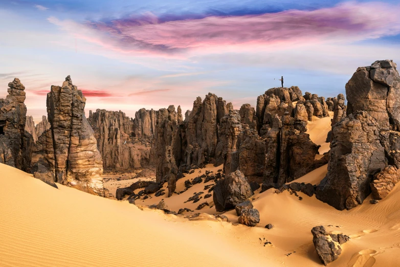 a desert scene with rocks and sand in the foreground, pexels contest winner, les nabis, tall stone spires, multicoloured, panoramic, nubian